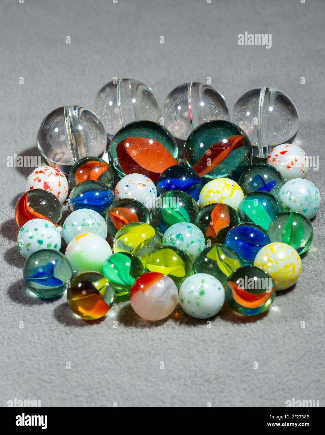 collection of various types and sizes of marbles grouped together Stock ...