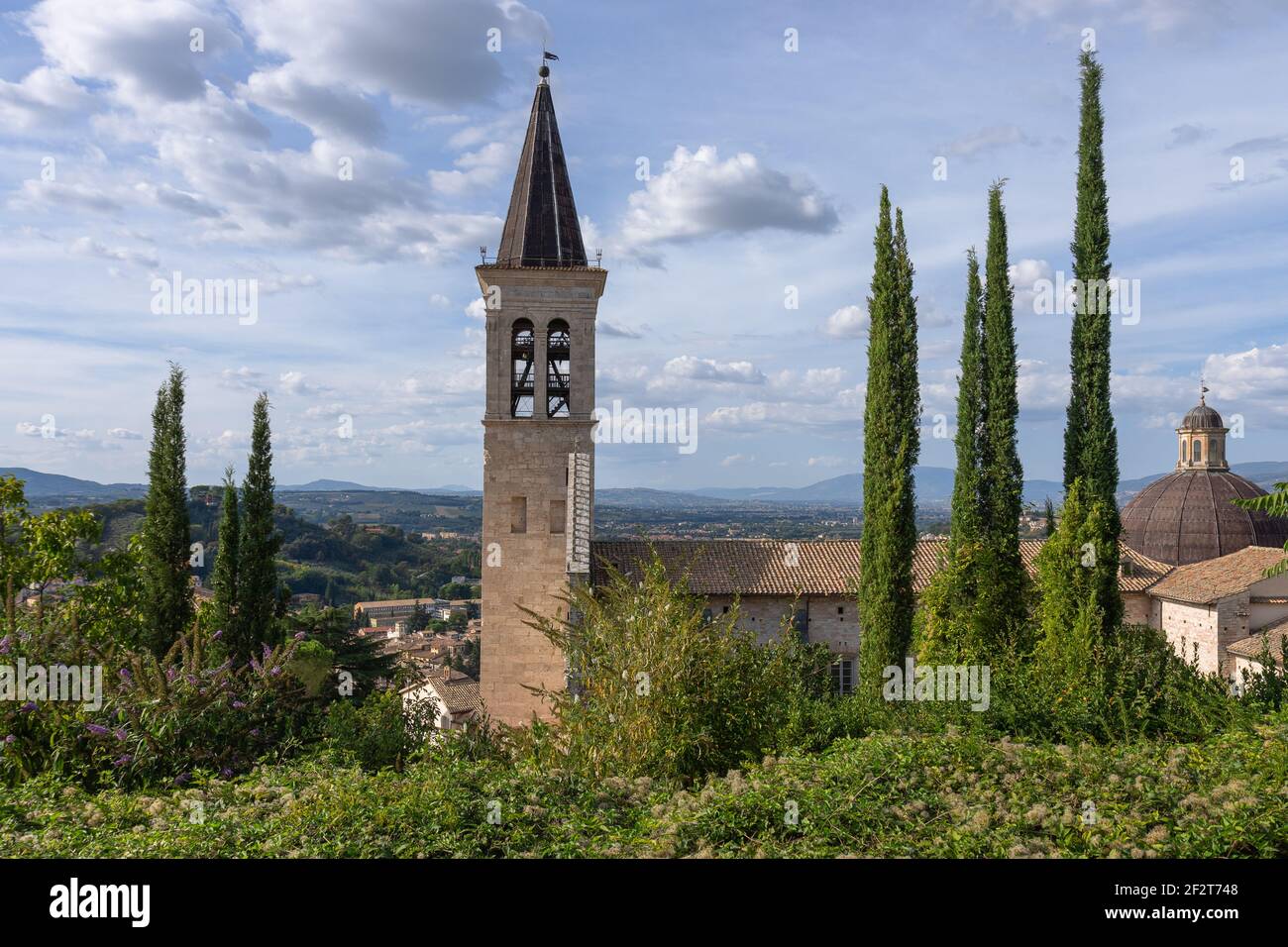 View of the bell tower of the medieval Cathedral of Santa Maria Assunta and the hills of Umbria. Spoleto, Italy Stock Photo