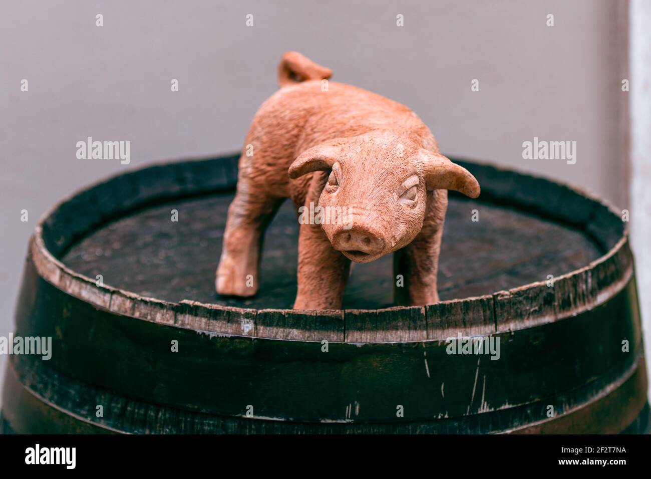 Сeramic toy pig on a wine barrel. Chinese horoscope year of the pig. 2019 new year of pig. Chinese New Year. Symbol of the new year 2019 Stock Photo