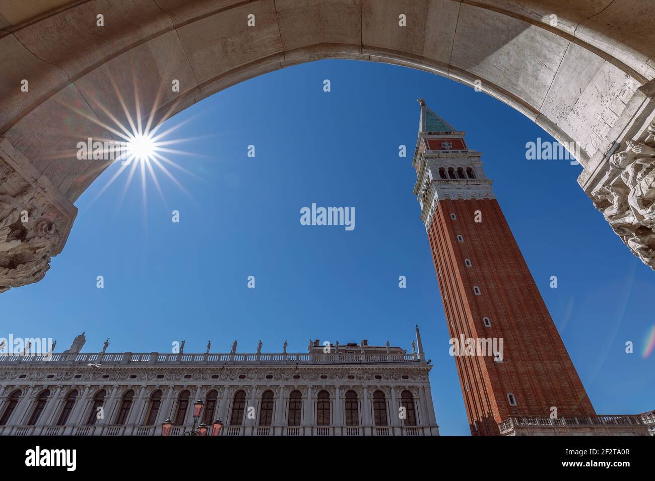 View from the arch of the Doge's Palace (Palazzo Ducale) to the famous St. Mark's Bell Tower (Campanile di San Marco). Venice, Italy Stock Photo