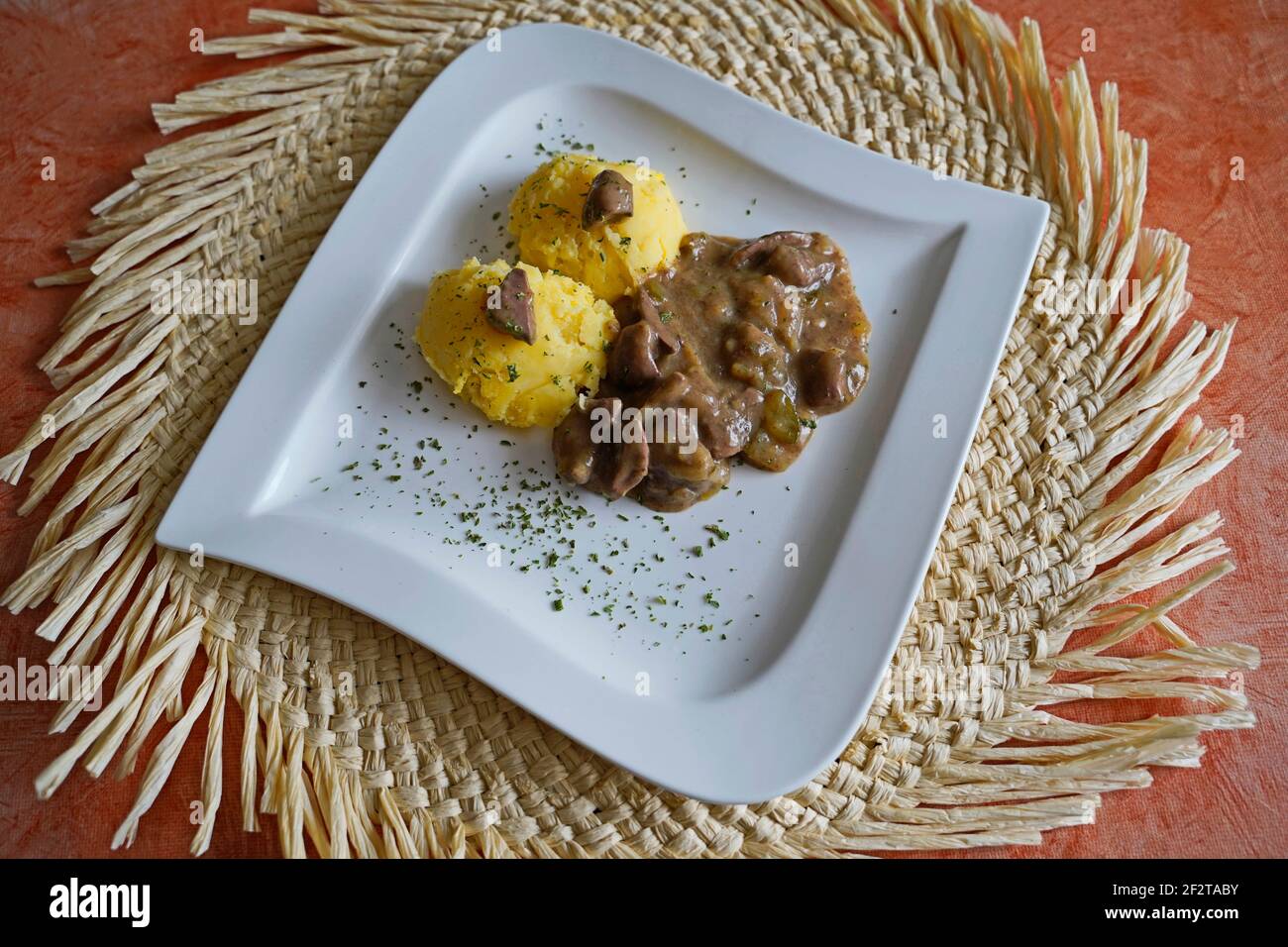 Mashed potatoes with kidney ragout on white plate Stock Photo Alamy