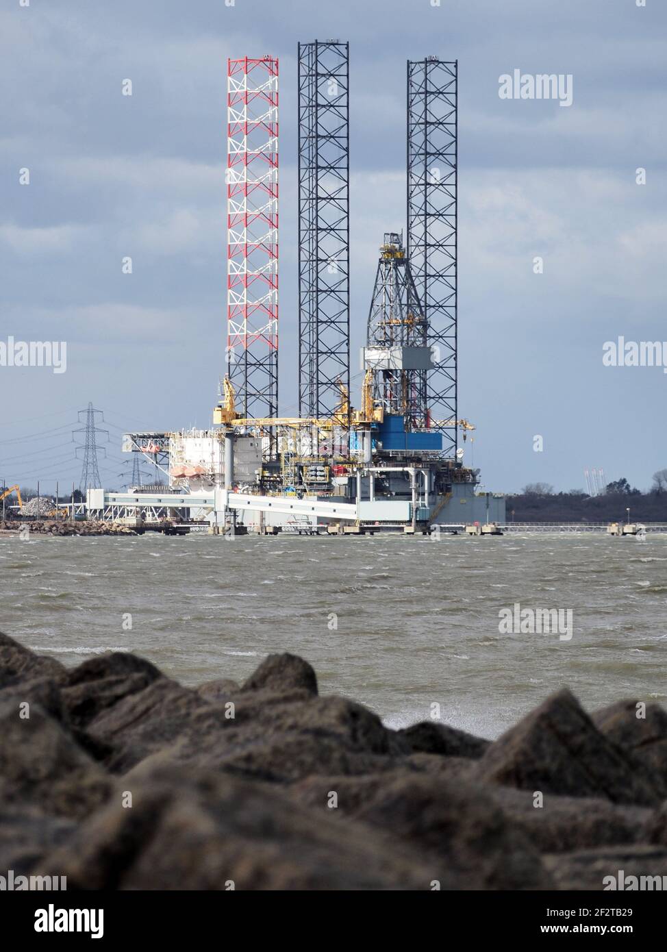 Sheerness, Kent, UK. 13th March, 2021. UK Weather: a windy and cold morning with some sunny spells in Sheerness, Kent. View towards 'Ran' drill rig. Credit: James Bell/Alamy Live News Stock Photo