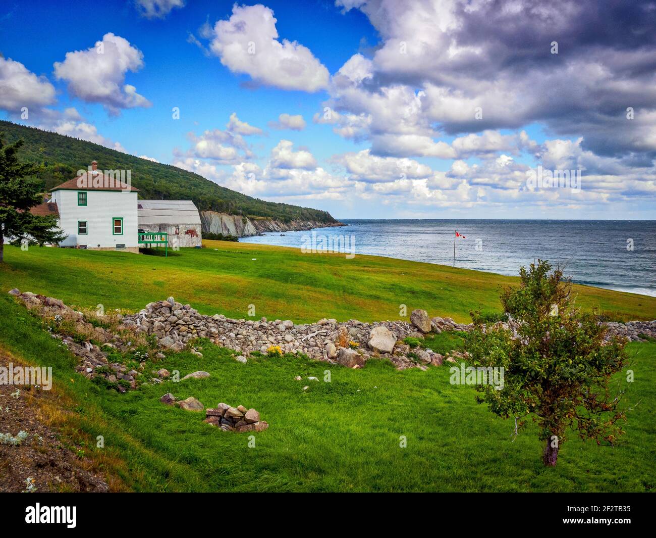 A lone dwelling house at remote Meat Cove in the far north of Cape Breton, Nova Scotia is accessible only by a long gravel track Stock Photo