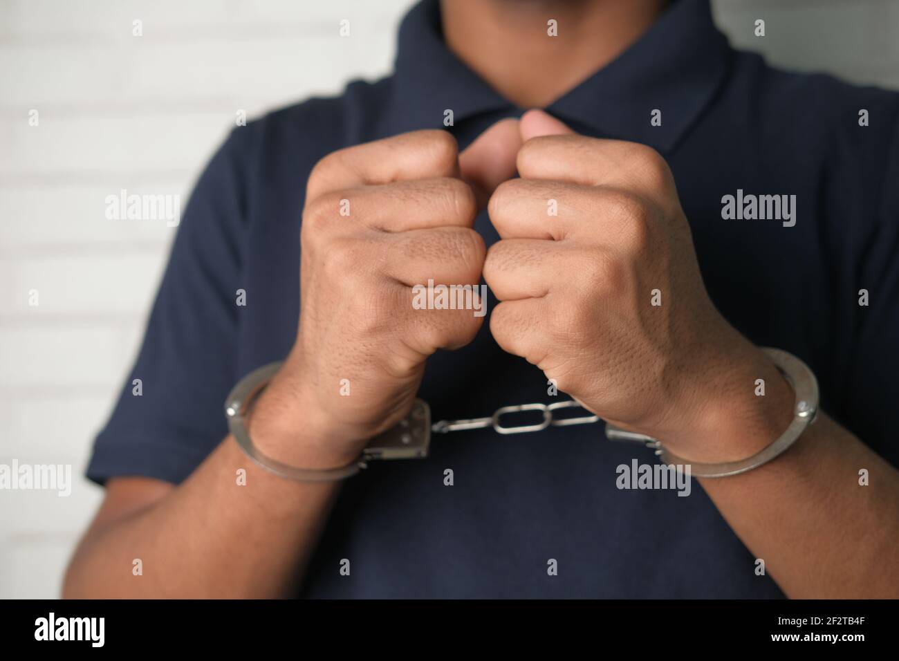 Girl in handcuffs and mask. in color lights. tied hands and