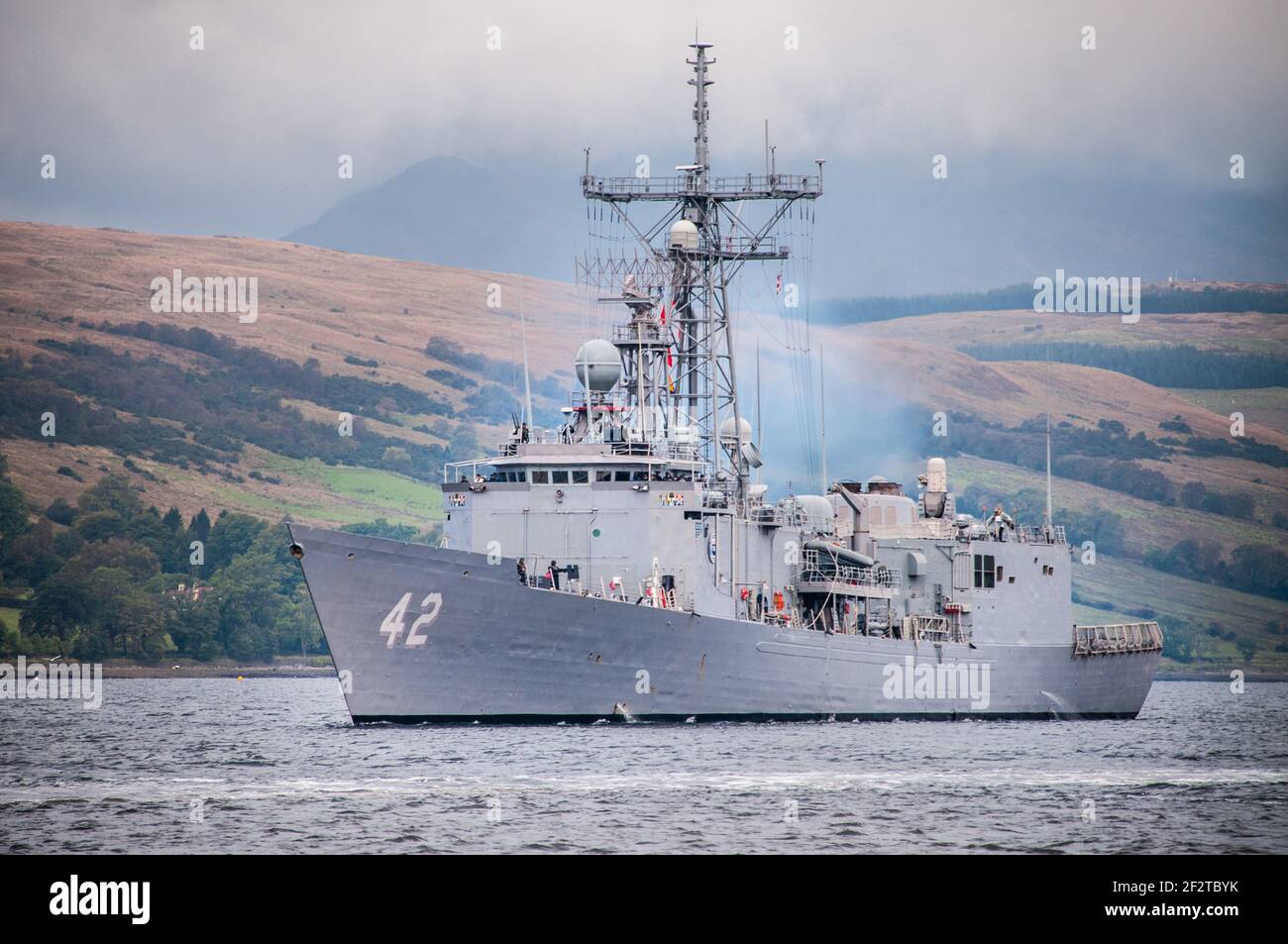 USS Klakring leaving the Gare Loch for NATO exercises of the west coast of Scotland, an Oliver Hazard Perry class frigate she was in service with the United States Navy from 1983 to 2013 Stock Photo