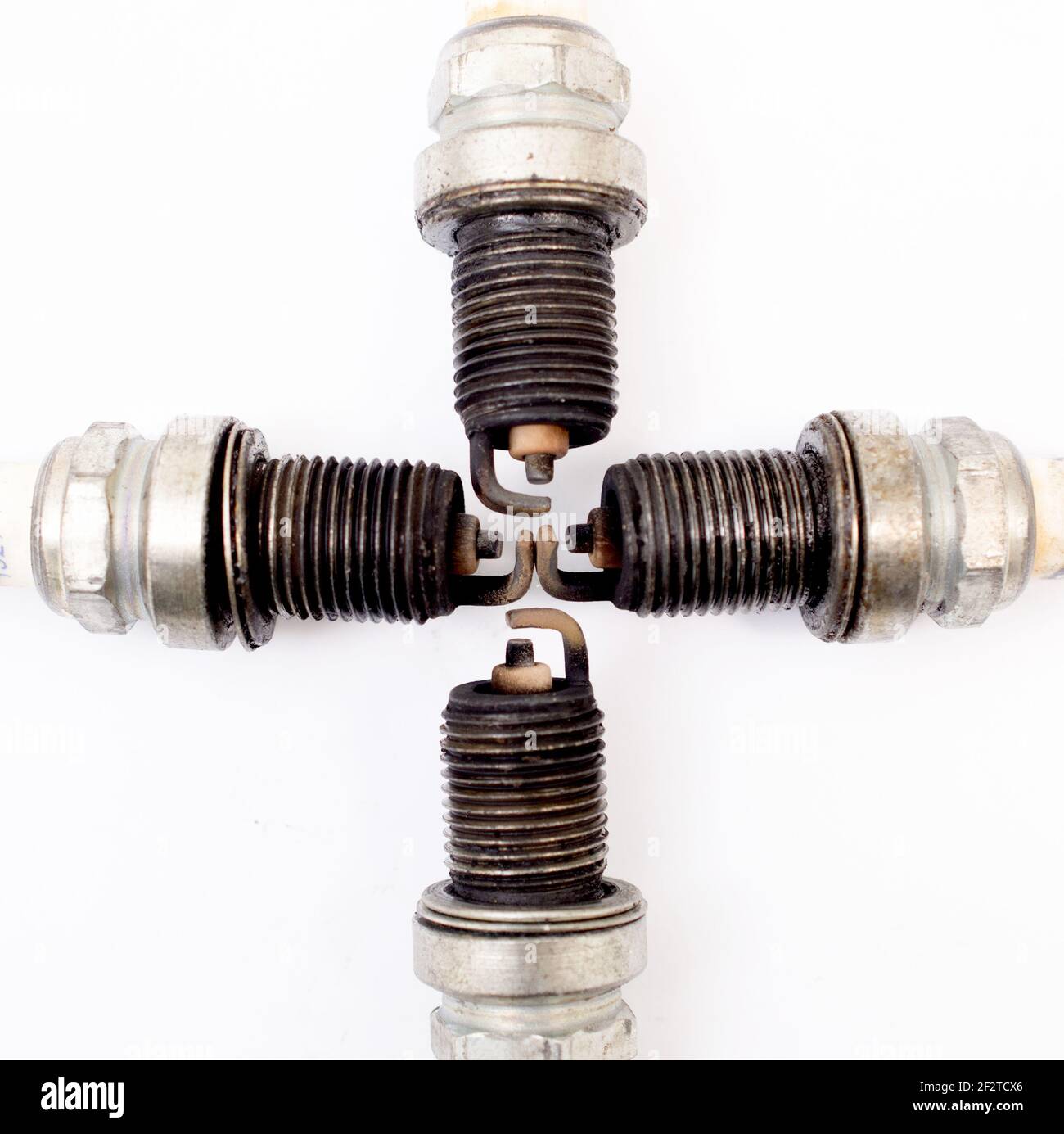 closeup shot of used spark plug on white background. Stock Photo