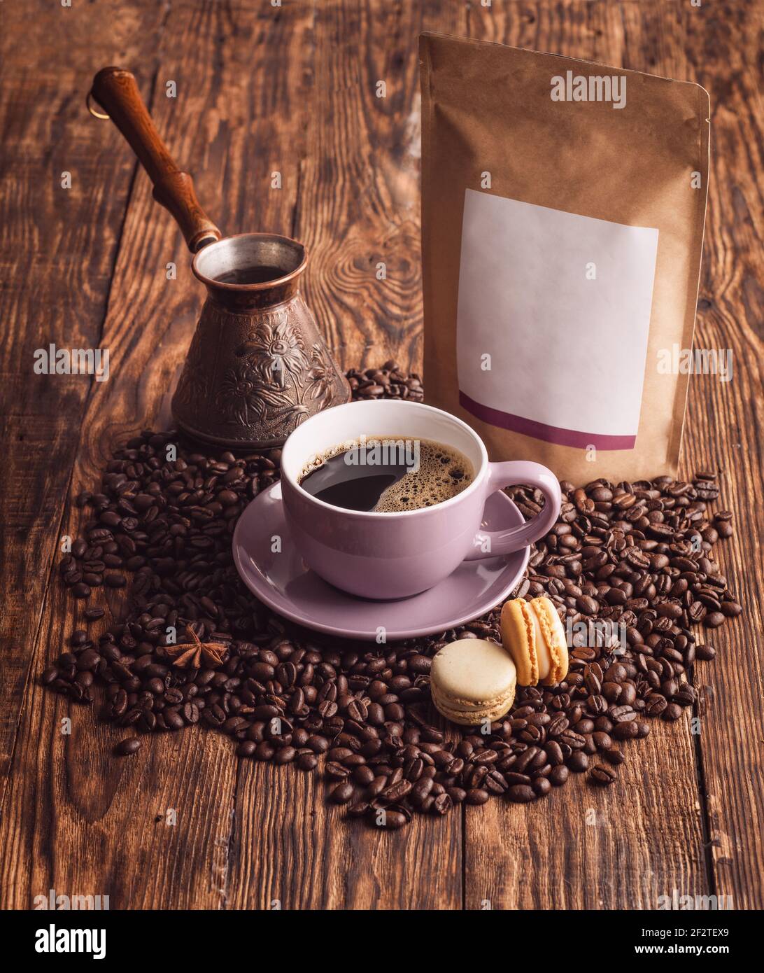 https://c8.alamy.com/comp/2F2TEX9/purple-cup-of-coffee-macaroons-beans-turkish-coffee-pot-and-craft-paper-pouch-bag-on-wooden-backgroun-2F2TEX9.jpg