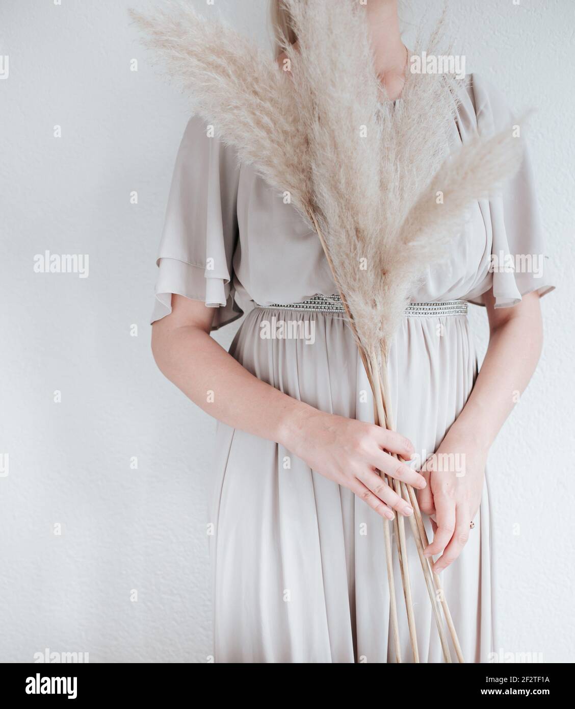 The woman is holding Pampas grass in her had, nordic living or minimalism design Stock Photo