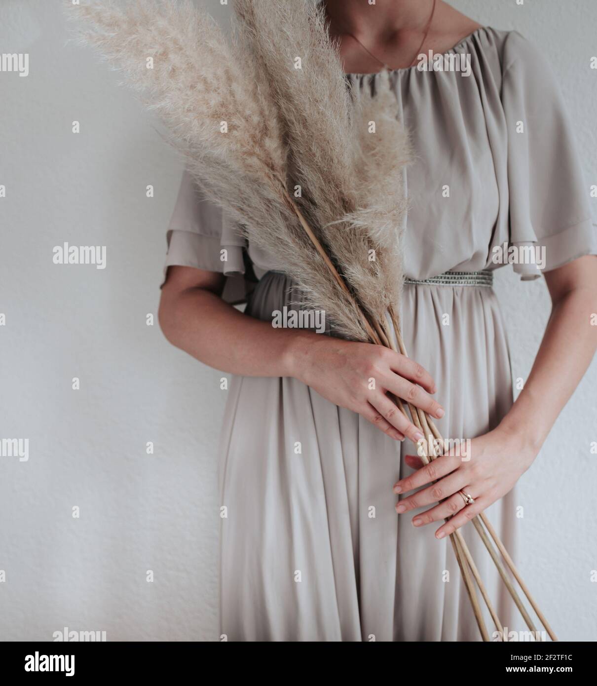 The woman is holding Pampas grass in her had, nordic living or minimalism design Stock Photo