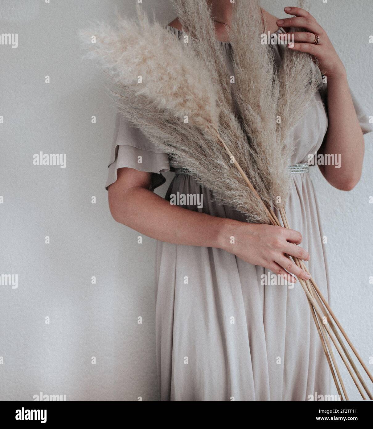 The woman is holding Pampas grass in her had, nordic living or minimalism design Stock Photo