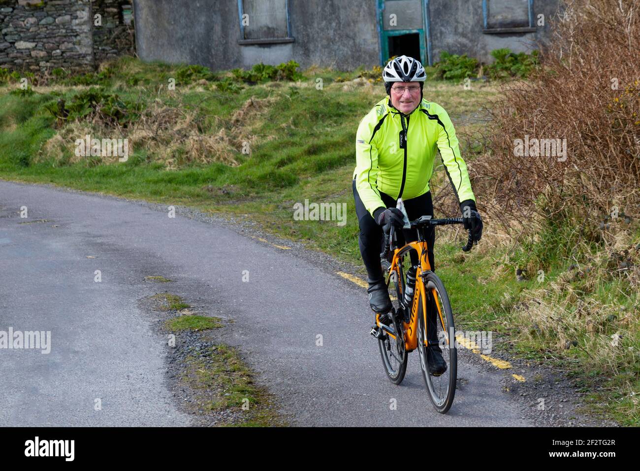 Co. Kerry, Ireland. 13th Mar 2021. Priest distributing shamrock on St. Patrick's Day to Parishioners by Bicycle, County Kerry, Ireland Credit: Stephen Power/Alamy Live News Stock Photo