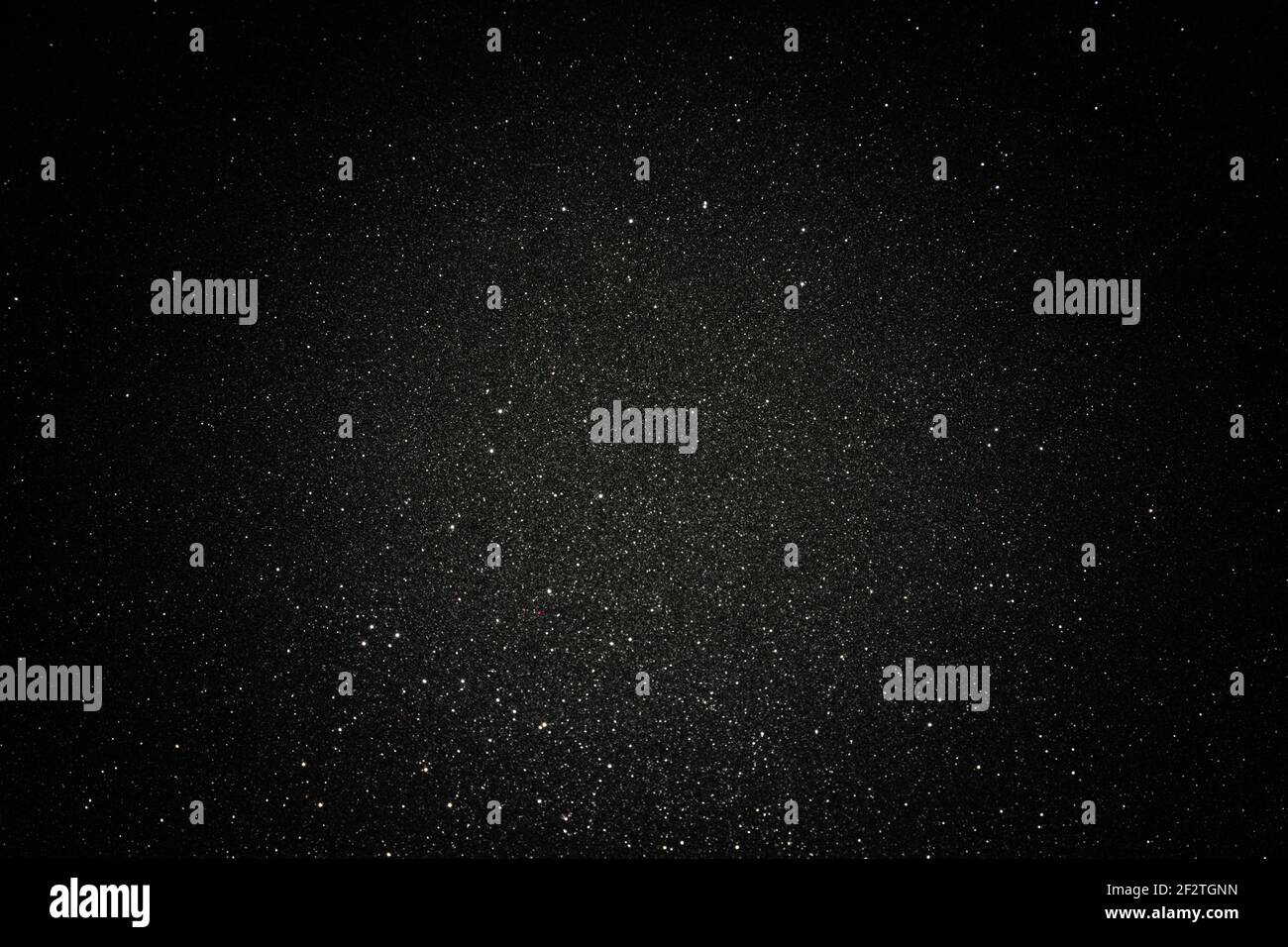 Black texture with micro-relief and glitter. Black glitter texture with illuminated center Stock Photo