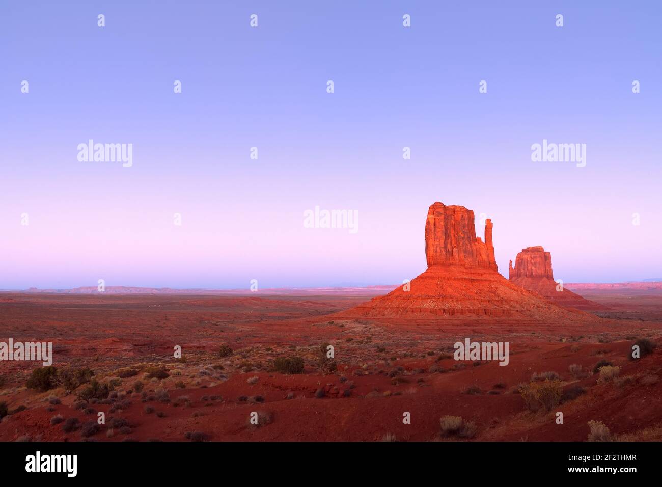 The last rays of the setting sun illuminate famous Buttes of Monument ...