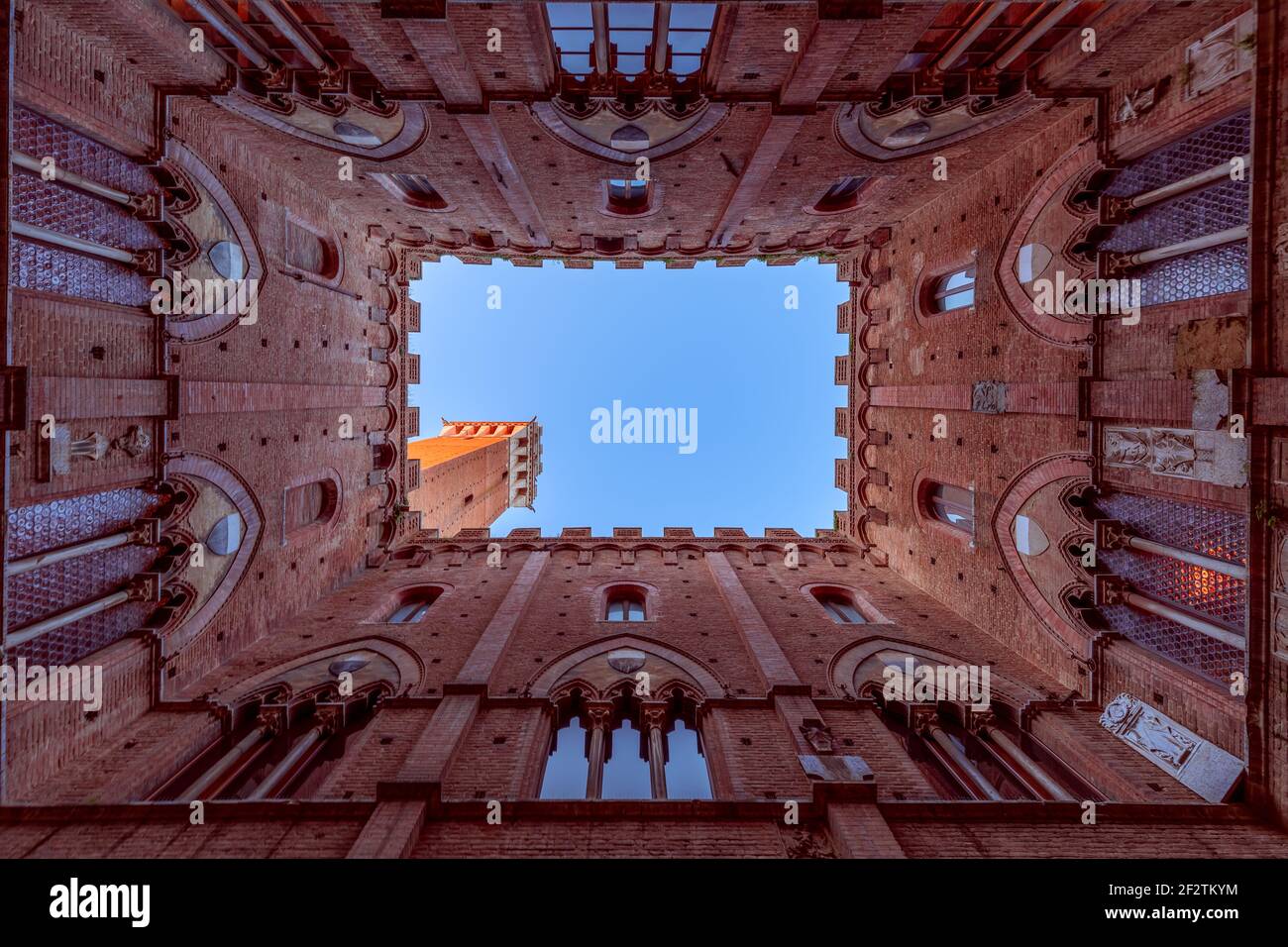 Wide angle view from the courtyard of Palazzo Pubblico to the famous Torre del Mangia. Siena, Tuscany, Italy Stock Photo