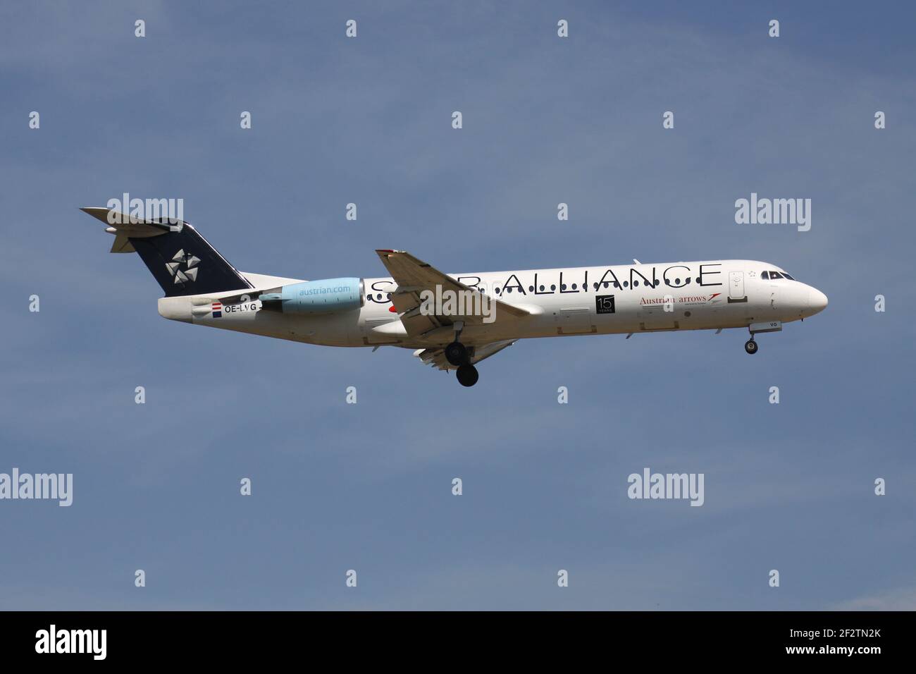Tyrolean Airways Fokker 100 in Austrian Arrows Star Alliance livery with registration OE-LVG on final for runway 07R of Frankfurt Airport. Stock Photo