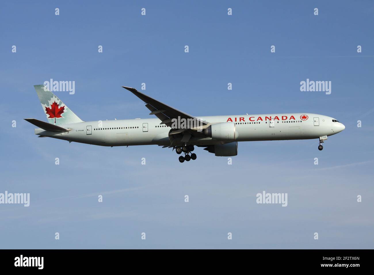 Air Canada Boeing 777-300 with registration C-FRAM on final for runway 07R of Frankfurt Airport. Stock Photo