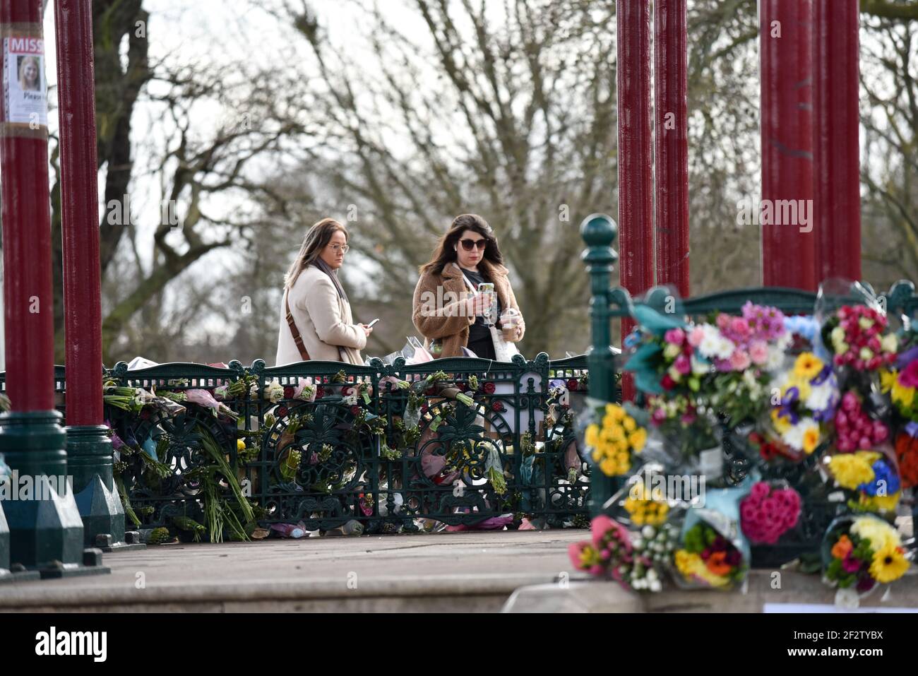 Clapham Common, London, UK. 13th Mar 2021. People paying their respects and laying floral tributes for Sarah Everard at the bandstand in Clapham Common. Credit: Matthew Chattle/Alamy Live News Stock Photo