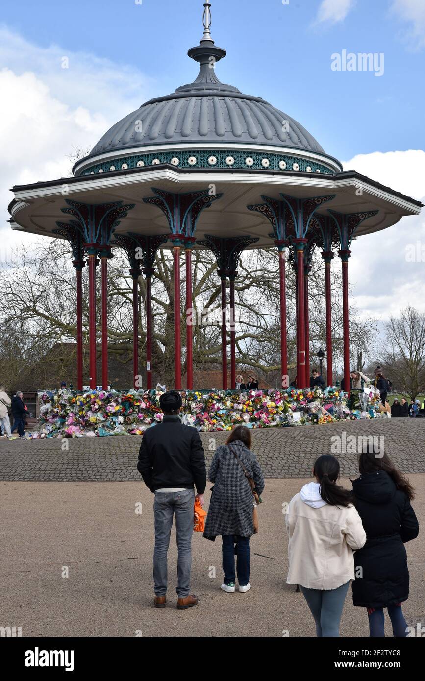 Clapham Common, London, UK. 13th Mar 2021. People paying their respects and laying floral tributes for Sarah Everard at the bandstand in Clapham Common. Credit: Matthew Chattle/Alamy Live News Stock Photo