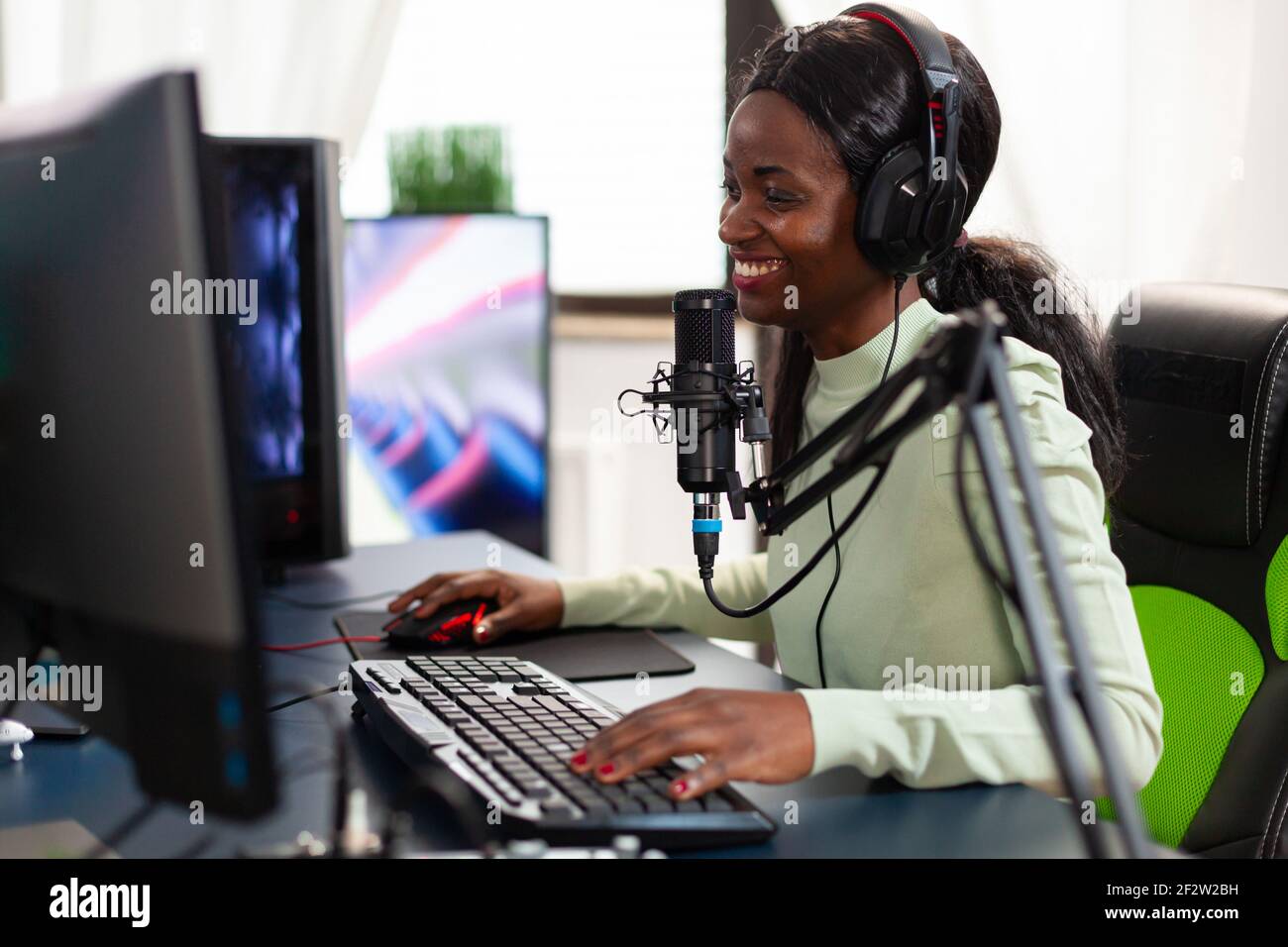 Premium Photo  Happy person live streaming video games tournament online  with multiple players, playing action esport game on computer. male  streamer with headset enjoying gaming competition.