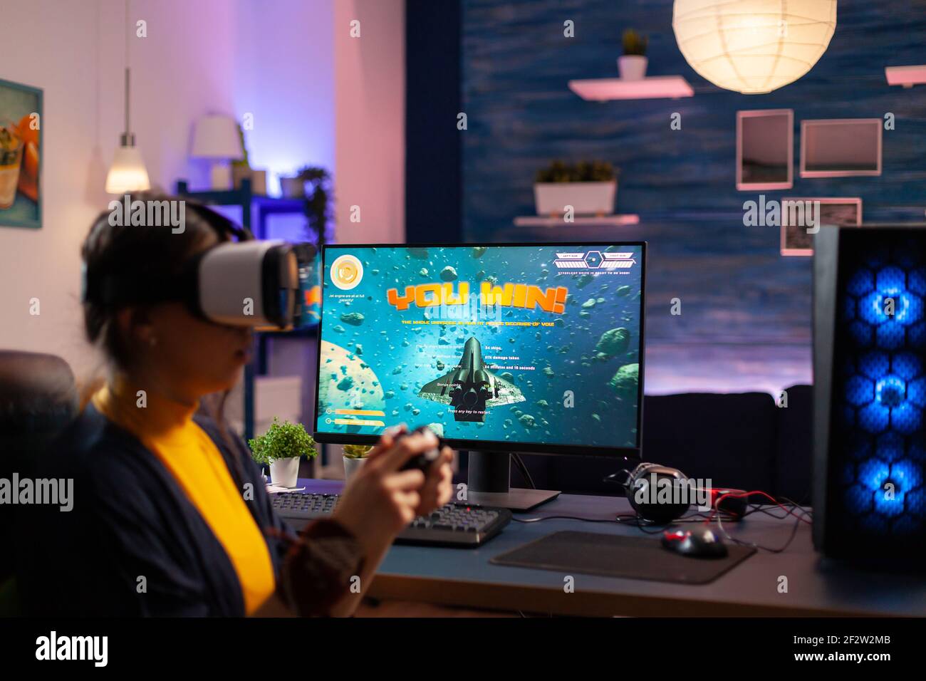 Back shot of pro gamer playing online shooter game on computer using  wireless controller. Competitive player man winning videogame tournament  use professional equipment at home gamming studio Stock Photo - Alamy