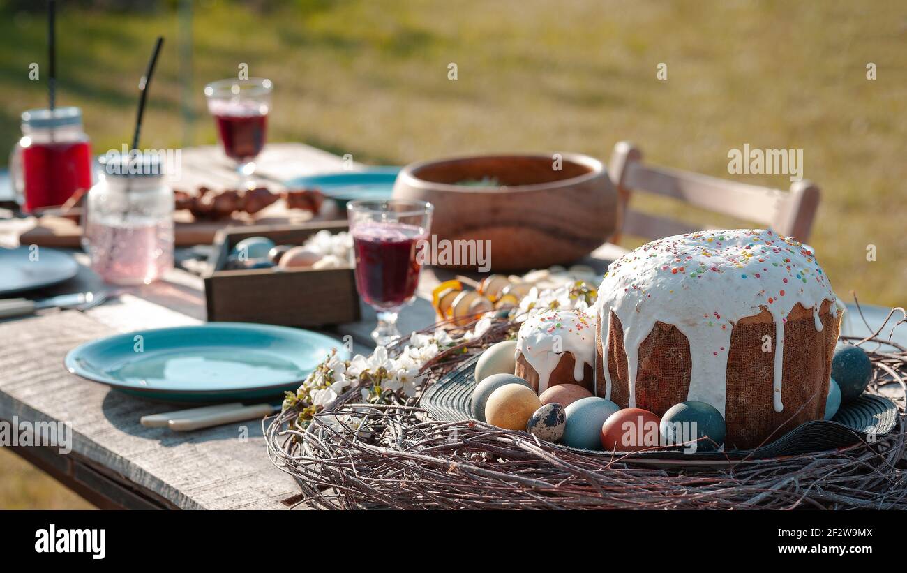 Served festive wooden table with dishes and food in the garden Stock Photo