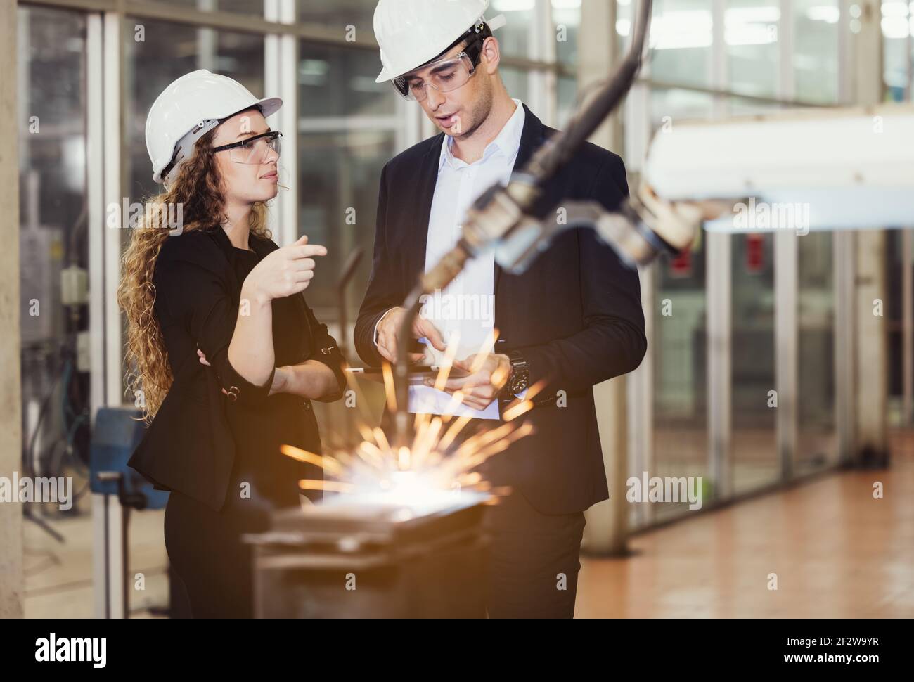 Engineer with digital tablet supervising autonomous producton process Stock Photo