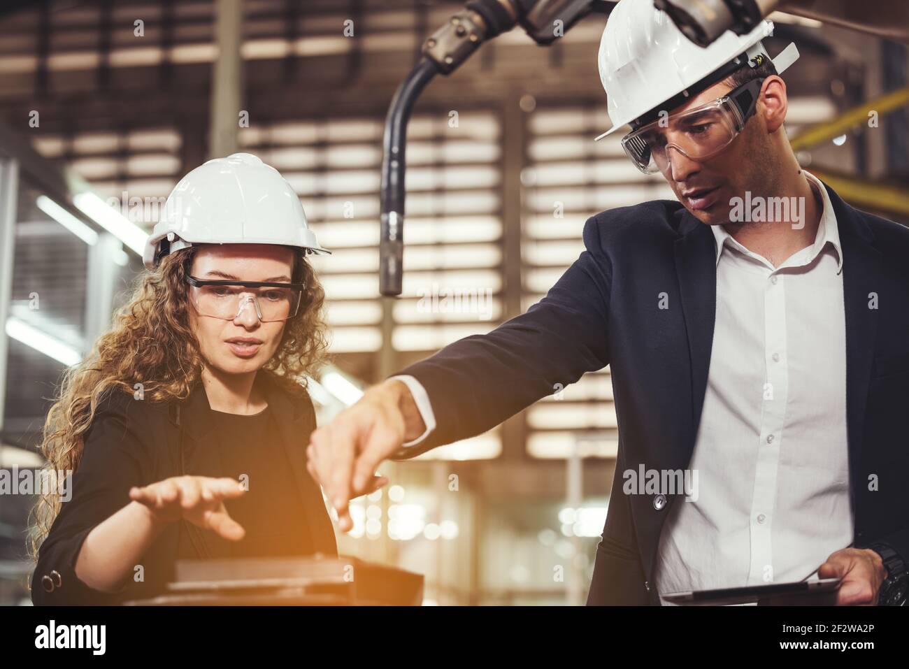 Engineer with digital tablet supervising autonomous producton process Stock Photo