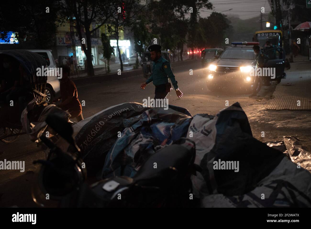 Dhaka, Dhaka, Bangladesh. 13th Mar, 2021. A police officer is seen walk fast to get shelter to escape the storm. The capital Dhaka of Bangladesh washed with a sudden heavy storm along with rains today afternoon. Credit: Fatima-Tuj Johora/ZUMA Wire/Alamy Live News Stock Photo