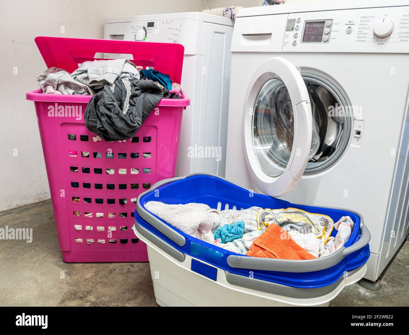 Washing machine and laundry basket at home Stock Photo