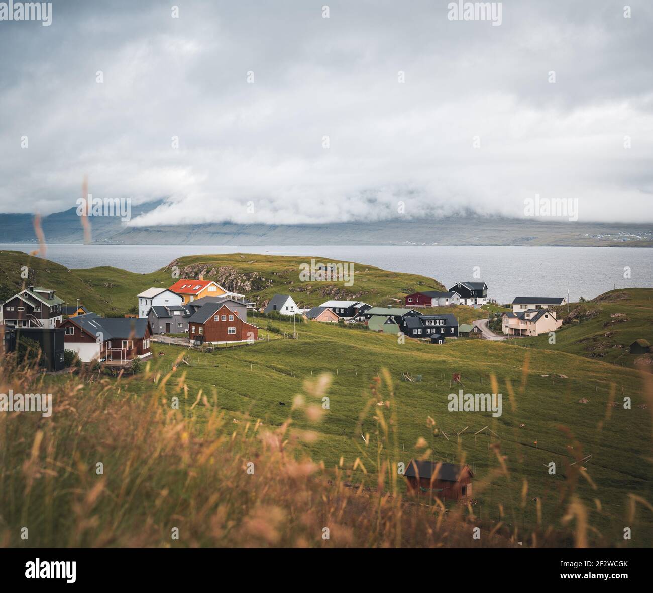 A small village on one of the Faroe Islands. The gloomy weather. Fog. Stock Photo