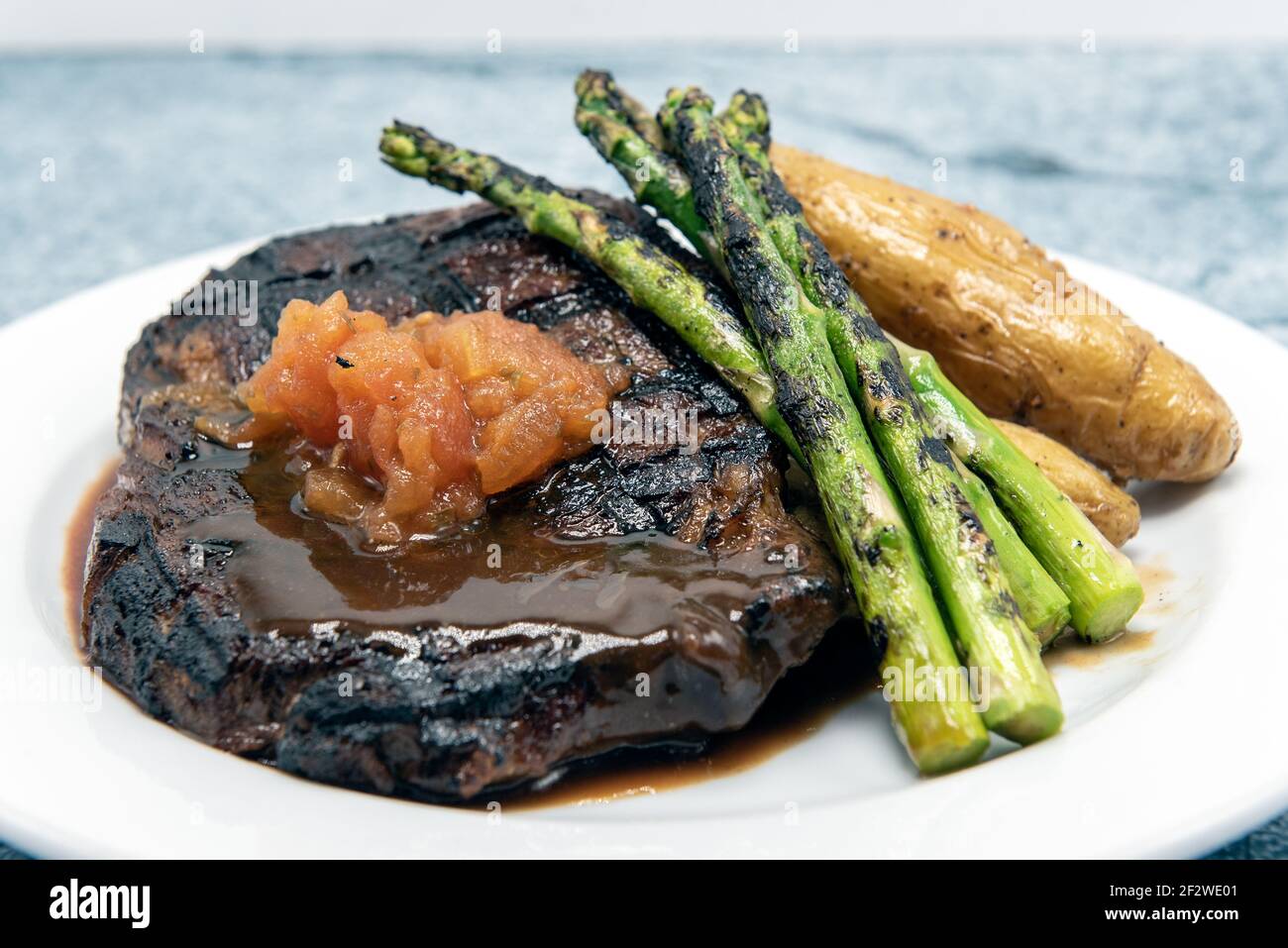 Grilled rib eye steak cooked to perfection served with asparagus