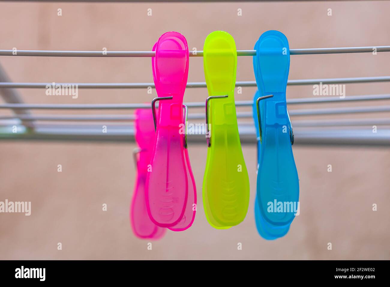 Colorful plastic clothes pegs on empty metal clothes dryer Stock Photo Alamy