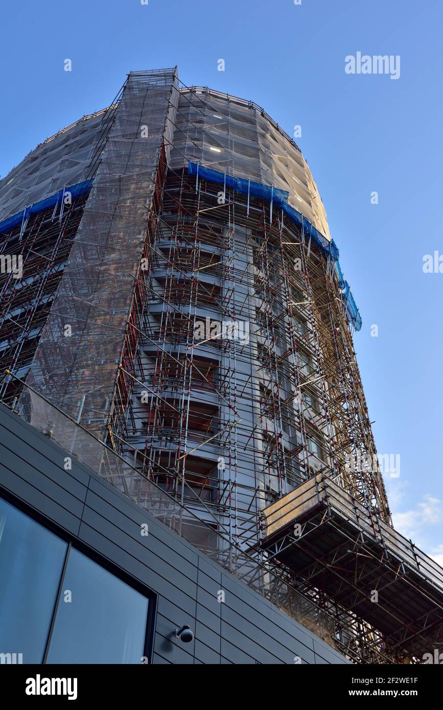 Newish private high rise tower building with flats having cladding removed to meet fire safety standards in new building code, UK Stock Photo