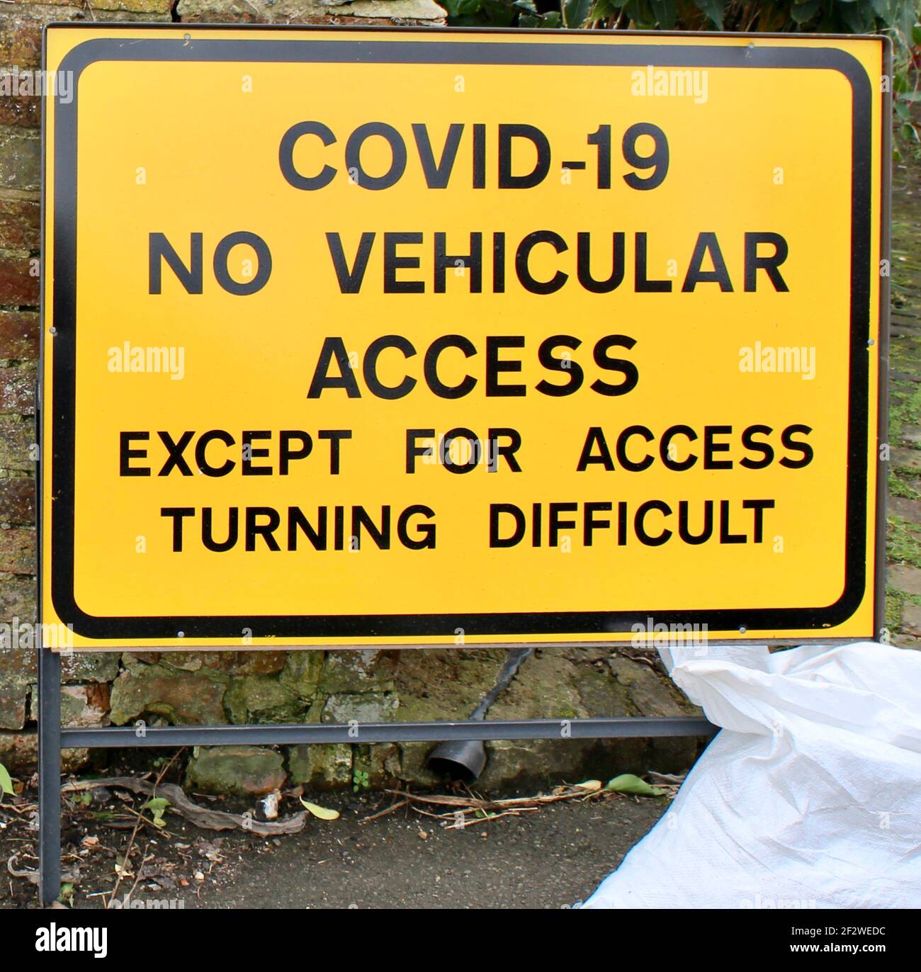 Covid-19 No Vehicular Access Except For Access Turning Difficult road sign. One of the road signs appearing during the coronavirus pandemic crisis Stock Photo