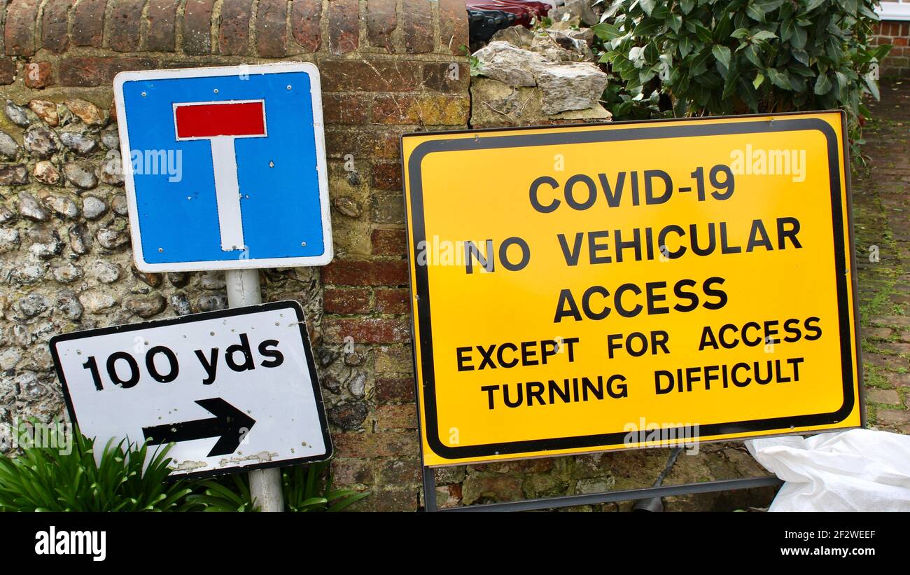 Covid-19 No Vehicular Access Except For Access Turning Difficult. Yellow warning road sign for drivers advising potential hazard as turning difficult. Stock Photo