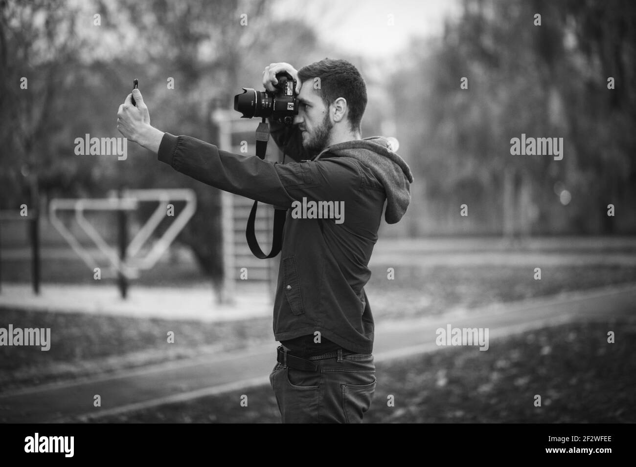 A portrait of a professional photographer on the action, taking a