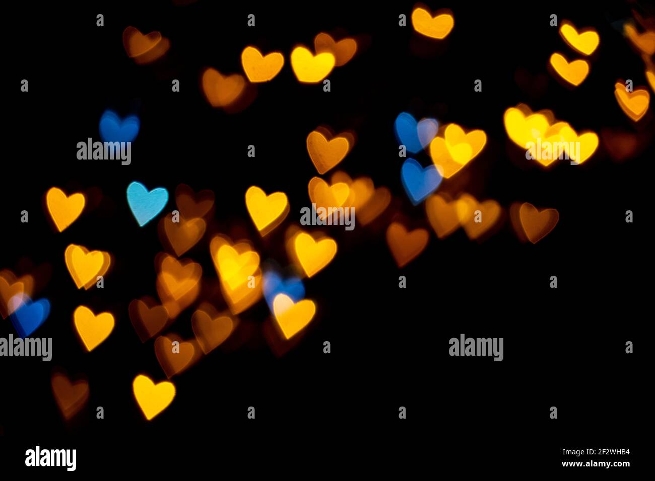 Valentine grunge heart shaped lights background. Yellow gold and ...