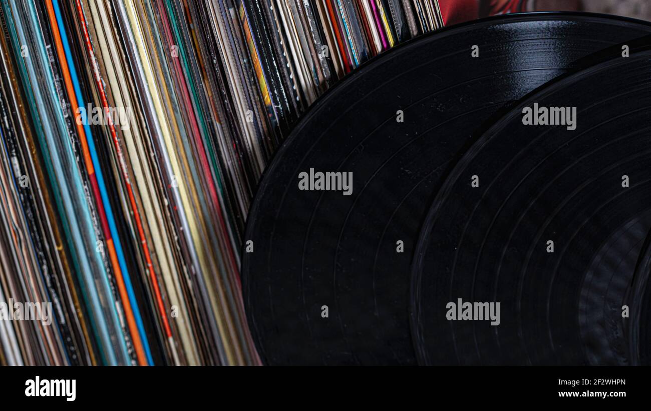 two records lean against a pile of records Stock Photo Alamy