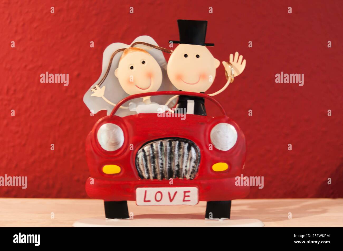 Wedding decorations, tin toys, bridal couple sitting in a bright red car Stock Photo - Alamy Wedding decorations, tin toys, bridal couple sitting in a bright red car Stock Photo - Alamy