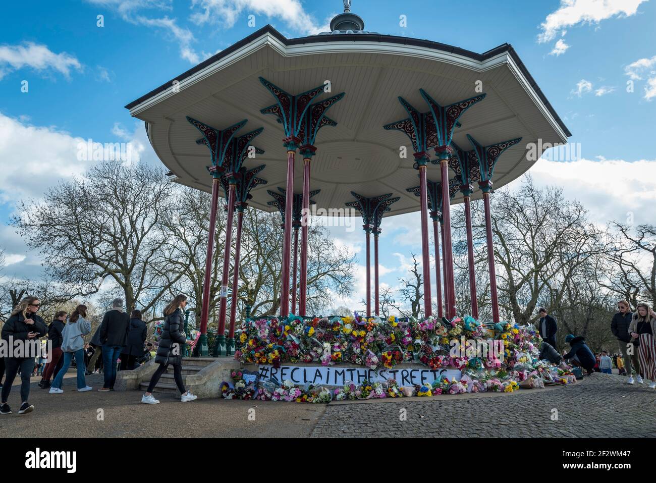 London, UK.  13 March 2021.  People lay floral tributes at the bandstand on Clapham Common to remember Sarah Everard.  Wayne Couzens, 48, a serving Met Police officer, has been charged with her kidnap and murder after she walked home close to Clapham Common in south London.  The 33-year-old's body was found in woodland in Kent more than a week after she was last spotted on 3 March.  Credit: Stephen Chung / Alamy Live News Stock Photo