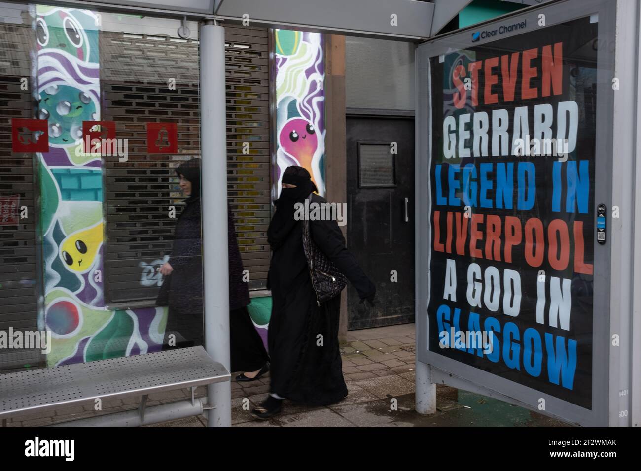 Glasgow, UK, on 13 March 2021. Posters celebrating last weekend’s Scottish Premiership title win by Rangers Football Club, their 55th such title, and proclaiming their manager, Steven Gerrard, a ‘God’, have appeared on bus shelters in the city’s Southside. It would appear the poster campaign is a guerrilla campaign, with unauthorised use of the advertising spaces. Photo credit: Jeremy Sutton-Hibbert/Alamy Live News. Stock Photo