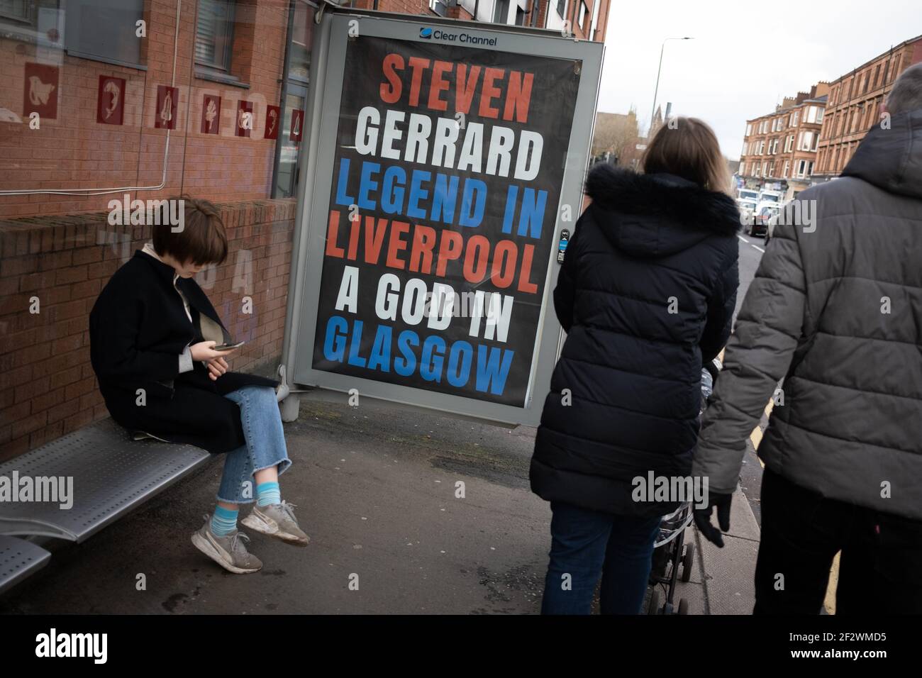 Glasgow, UK, on 13 March 2021. Posters celebrating last weekend’s Scottish Premiership title win by Rangers Football Club, their 55th such title, and proclaiming their manager, Steven Gerrard, a ‘God’, have appeared on bus shelters in the city’s Southside. It would appear the poster campaign is a guerrilla campaign, with unauthorised use of the advertising spaces. Photo credit: Jeremy Sutton-Hibbert/Alamy Live News. Stock Photo