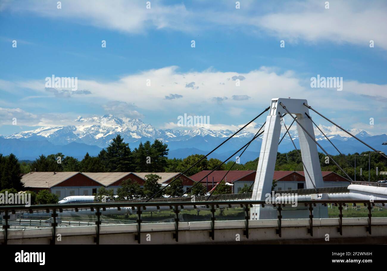 Milan Malpensa Airport. View from the airport entrance towards the snow-capped Alps. Stock Photo