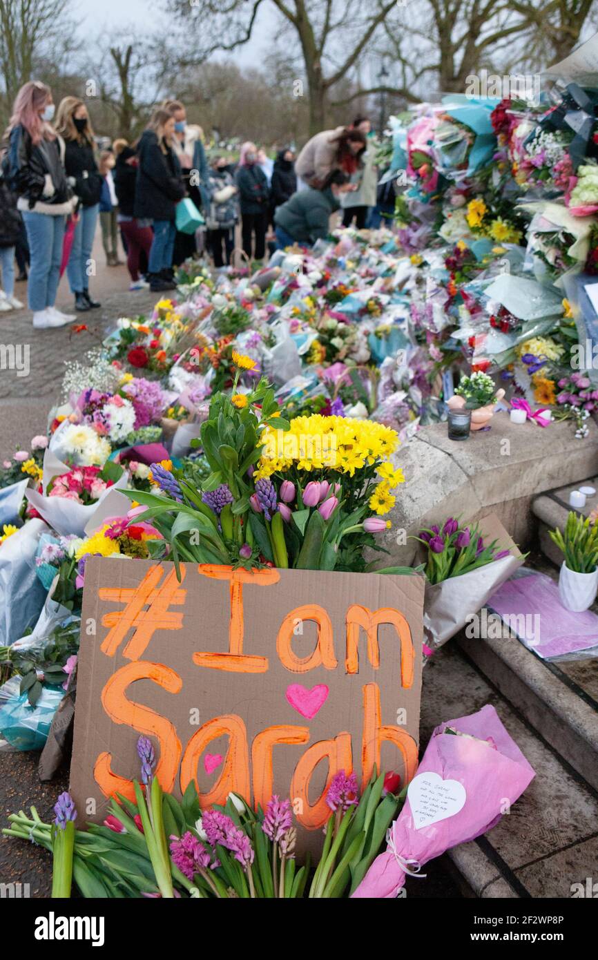 London, UK, 13 March 2021: A memorial of flowers for Sarah Everard draws hundreds of well wishers at Clapham Common bandstand. Tributes included plants, flowers, candles and messages such as 'When Will Women be Safe?' and 'She was only walking home.' An official vigil has been cancelled due to police concerns over coronavirus. Anna Watson/Alamy Live News Stock Photo