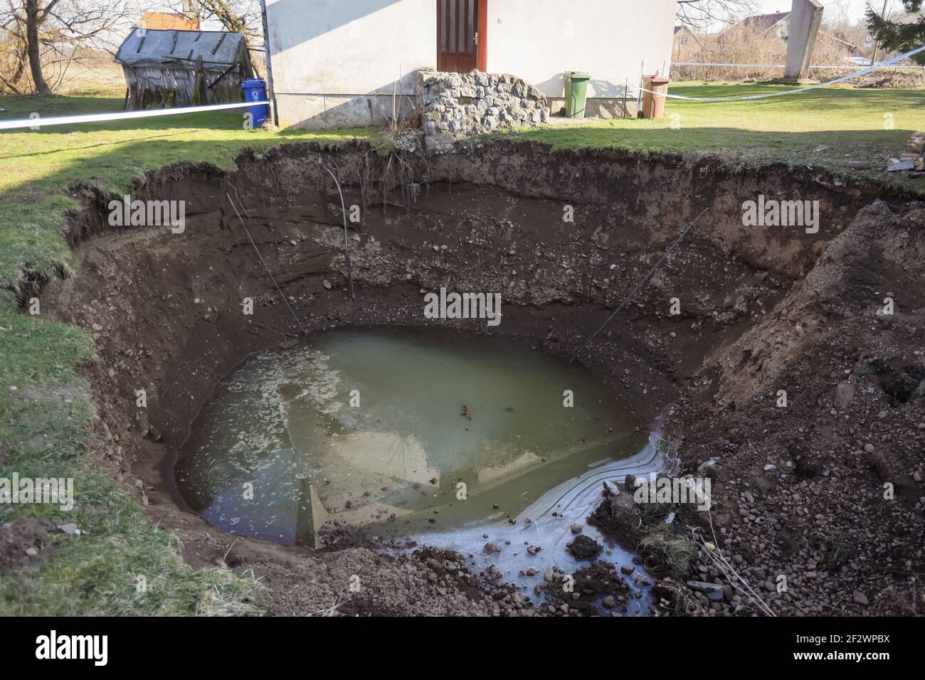 In the village of Mecencani, after a magnitude 6.2 earthquake, holes were opened in the ground, most of which springs water. Some holes have opened ne Stock Photo