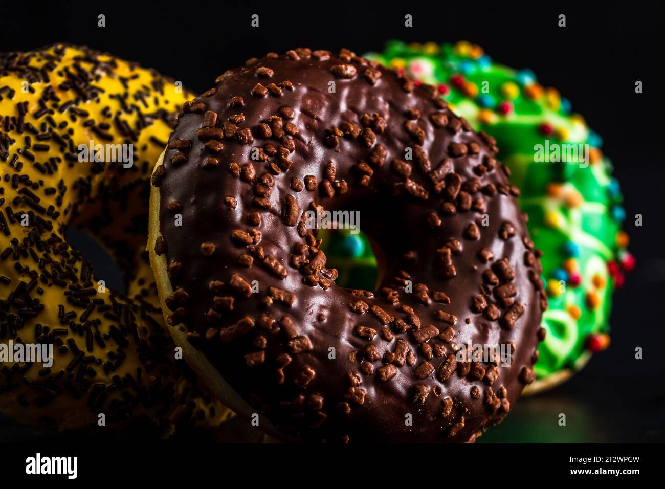Glazed donuts with sprinkles isolated. Close up of colorful donuts ...