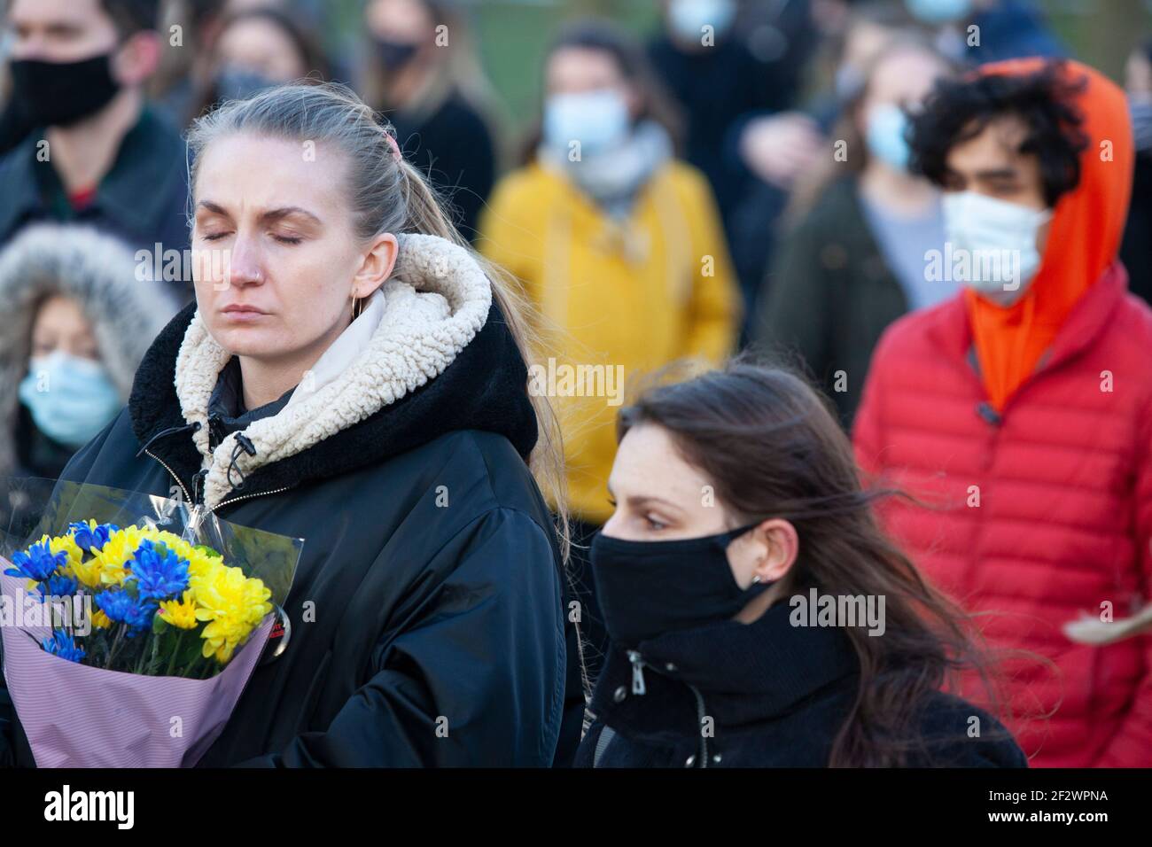 London, UK, 13 March 2021: A memorial of flowers for Sarah Everard draws hundreds of well wishers at Clapham Common bandstand. Tributes included plants, flowers, candles and messages such as 'When Will Women be Safe?' and 'She was only walking home.' An official vigil has been cancelled due to police concerns over coronavirus. Anna Watson/Alamy Live News Stock Photo