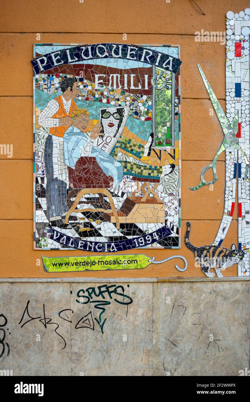 Artistic barber shop sign made of tiles. Beautiful mosaic in the streets of Valencia, Spain Stock Photo