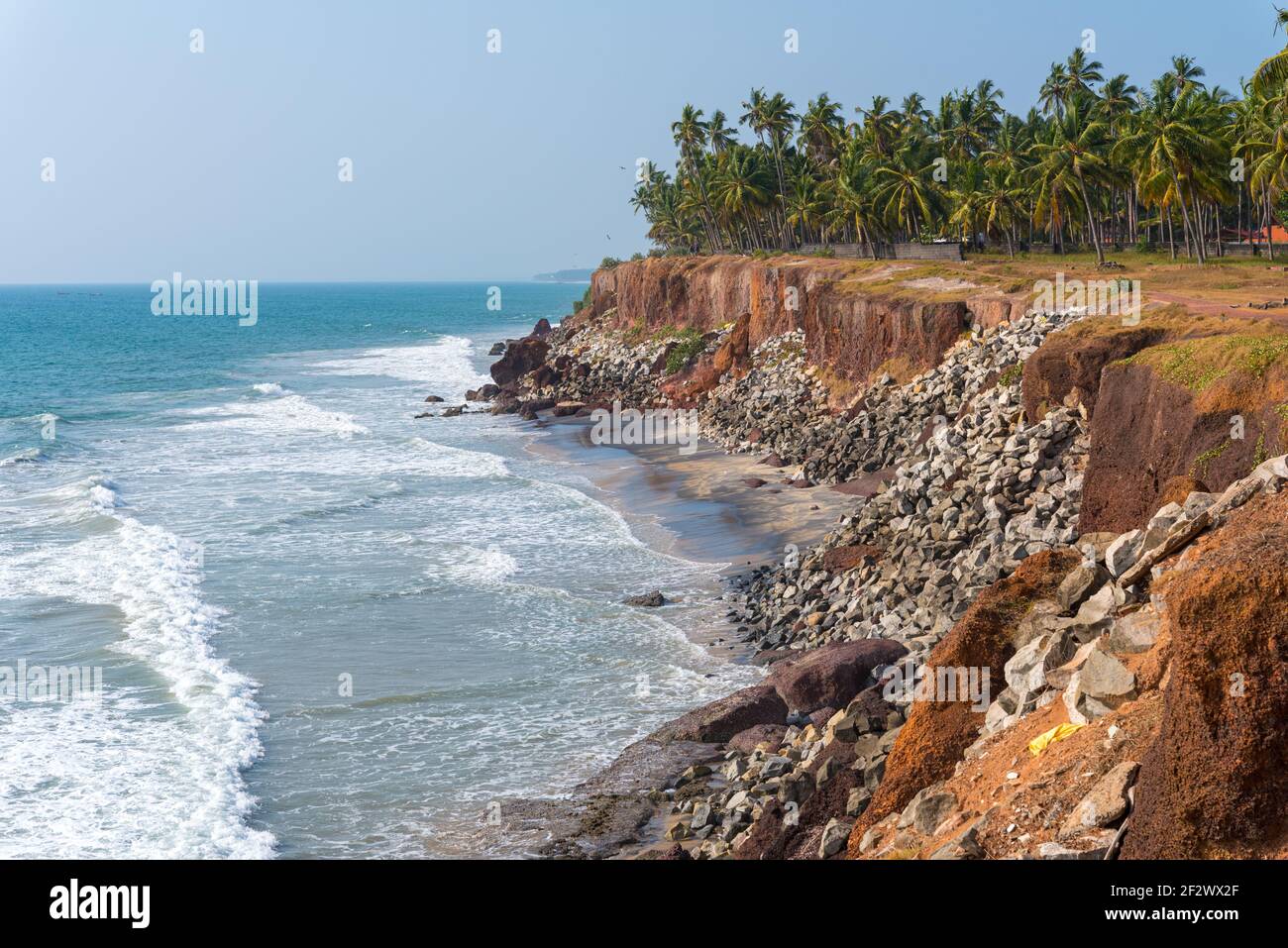 Sea shore protection measures in India - steep coastline strengthened with stones.Varkala, Kerala, India. Stock Photo