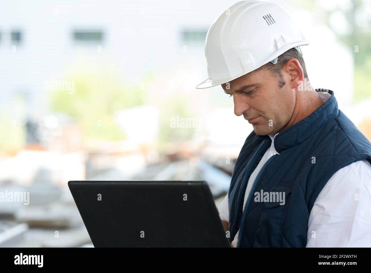 engineer working with laptop outdoors Stock Photo